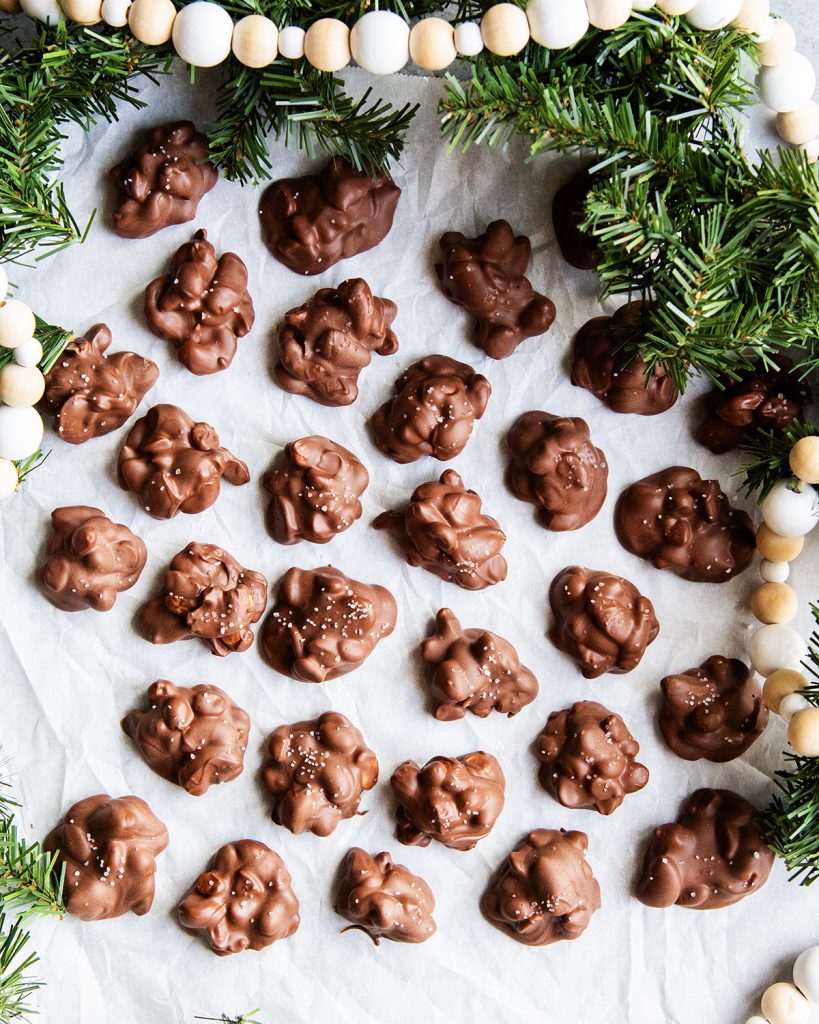 An overhead of chocolate nut clusters on parchment paper.