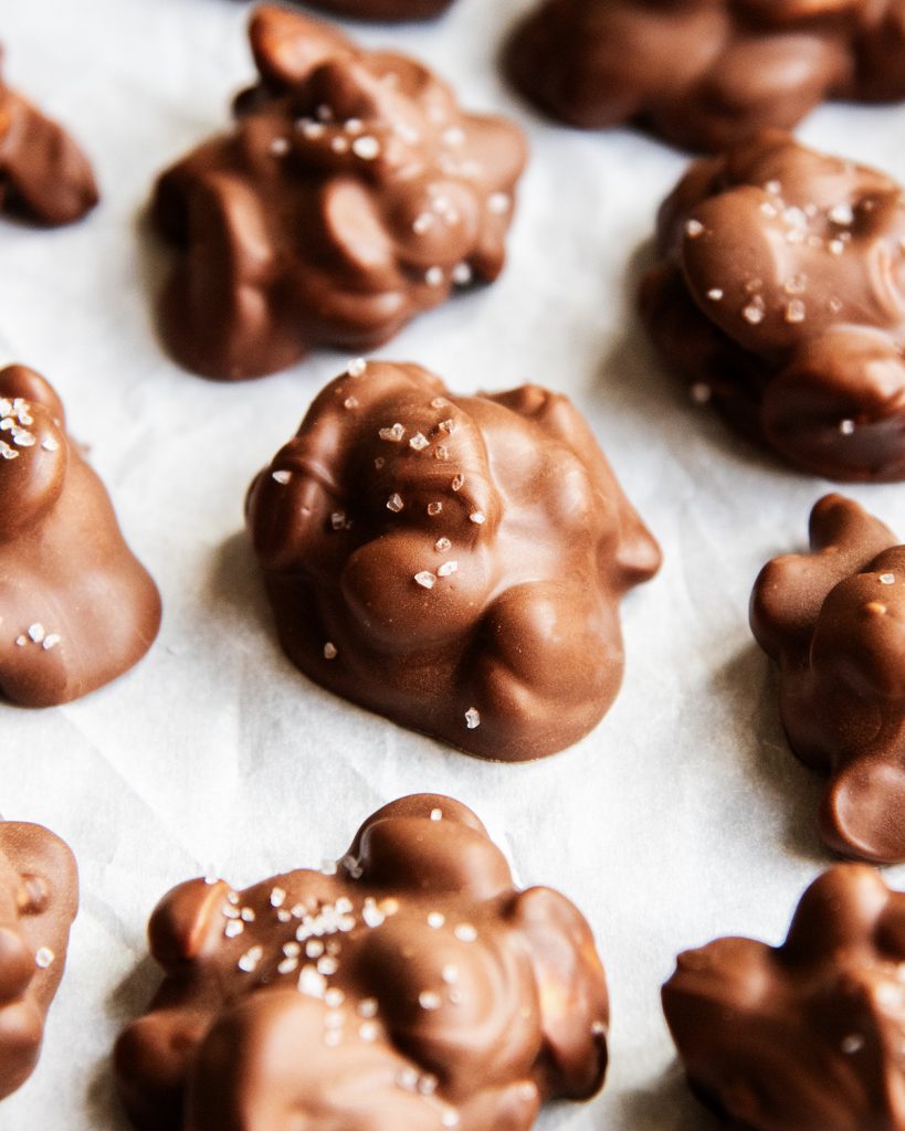 Nut clusters coated in chocolate and topped with coarse salt.