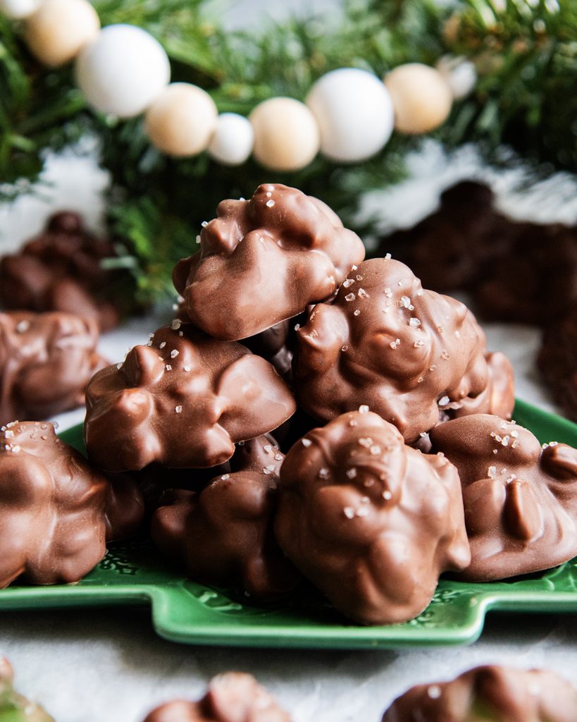 A pile of chocolate nut clusters on a green plate.