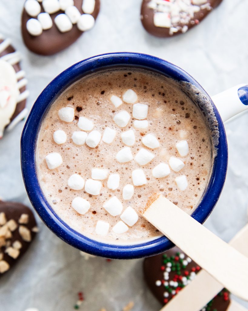 A cup of hot cocoa topped with mini marshmallows.