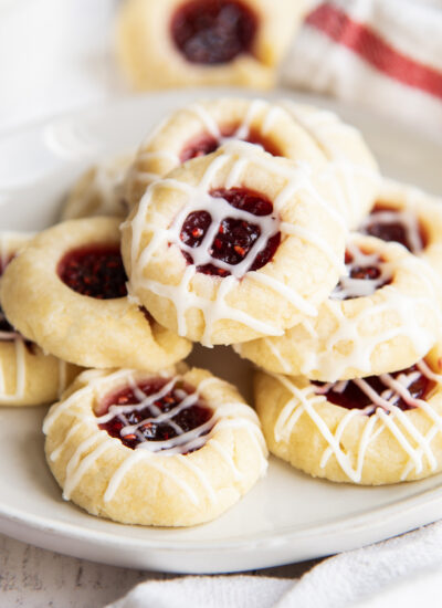 A pile of thumbprint cookies on a plate.
