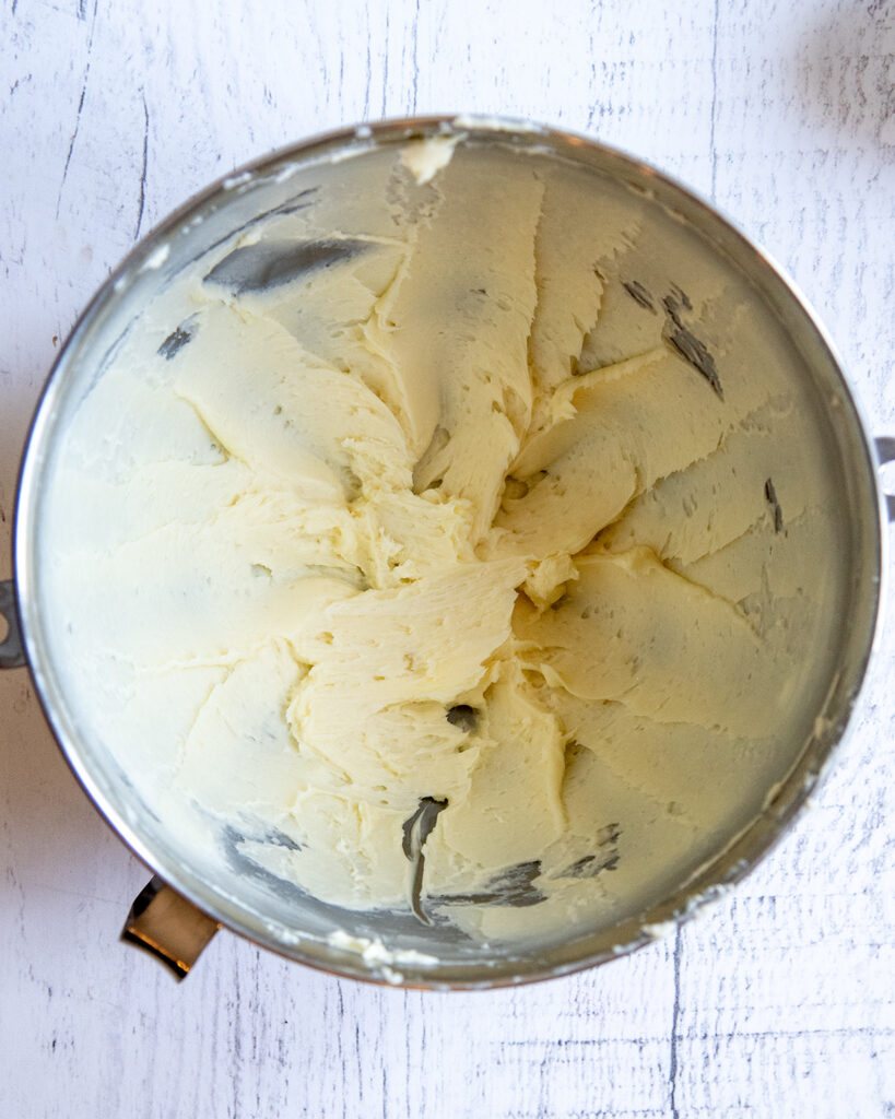 A mixing bowl full of creamed butter and sugar. 