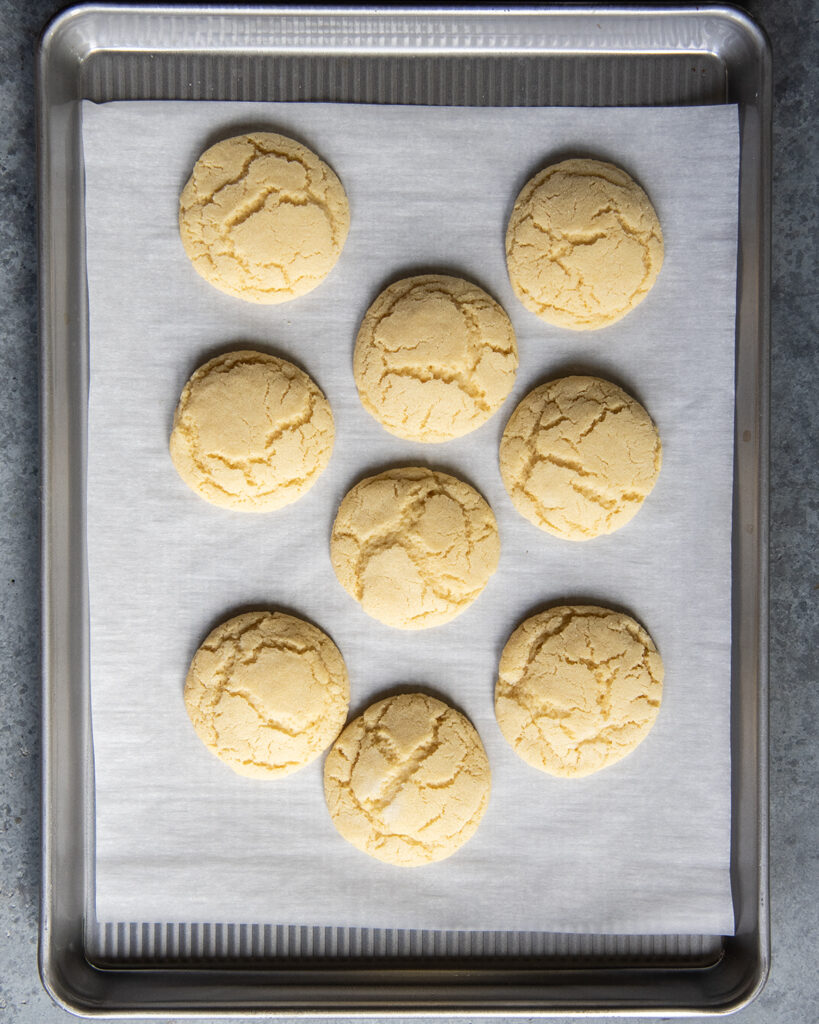 Drop sugar cookies on a cookie sheet lined with parchment paper.
