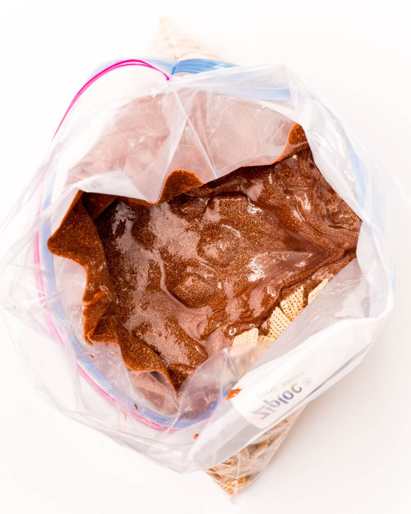 Melted chocolate poured over chex cereal in a ziplock bag.