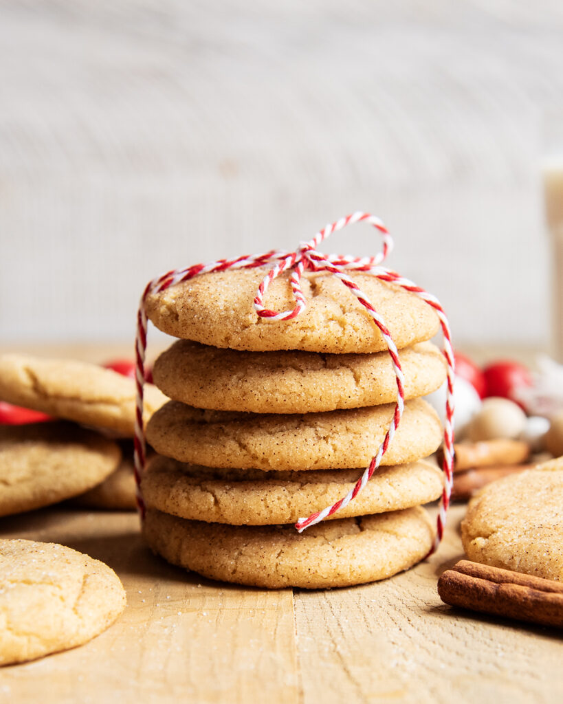 A side view of stack of 5 snickerdoodle cookies tied with a red and white twine.