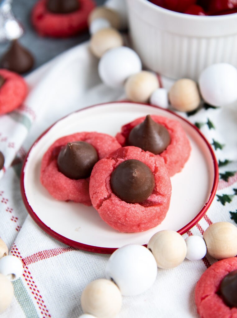 A plate of three red Cherry Blossom cookies.