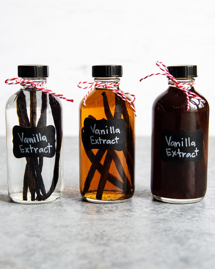 Three glass bottles labeled vanilla extract.
