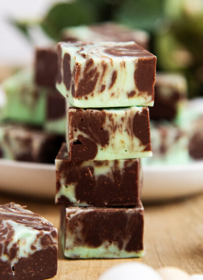 A stack of 4 pieces of fudge swirled with chocolate and green fudge.