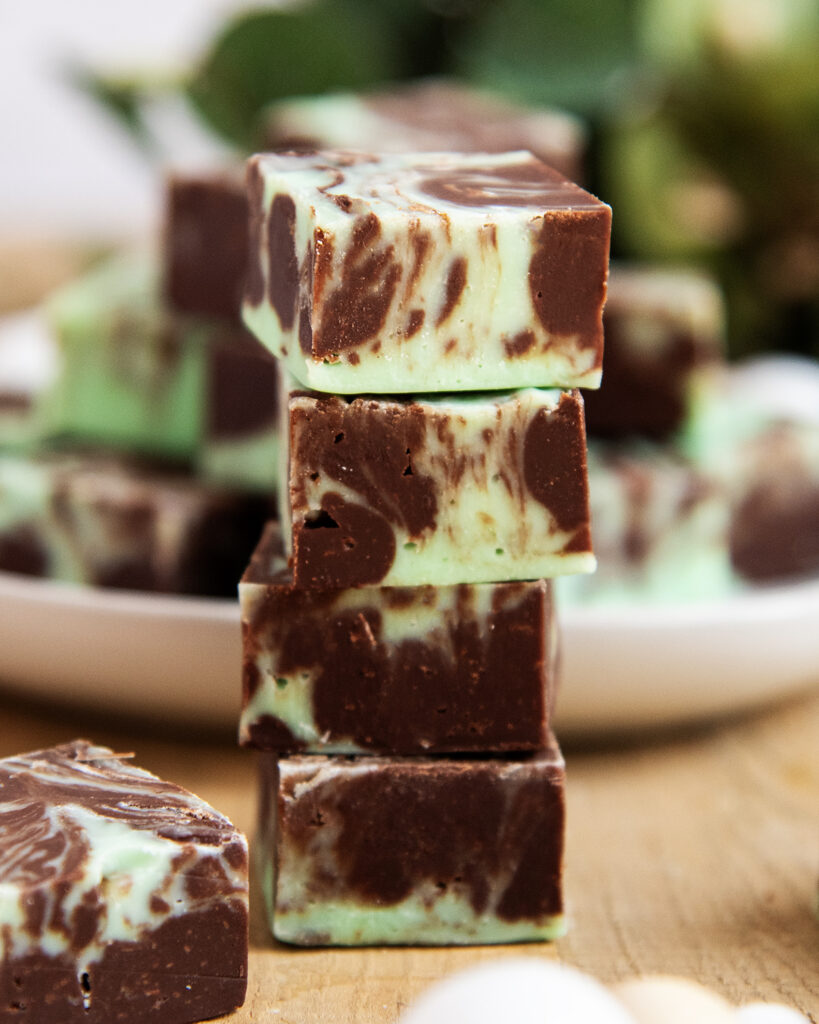 A stack of 4 pieces of fudge swirled with chocolate and green fudge.