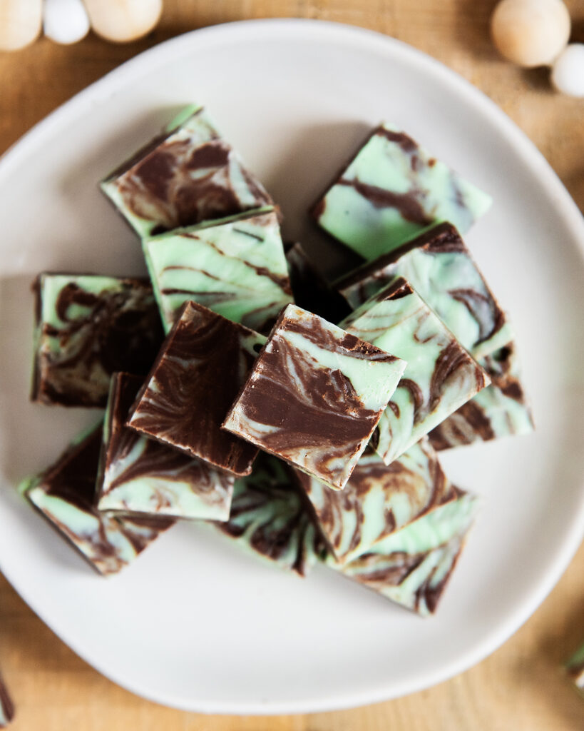 An above view of a plate of a pile of swirled mint chocolate fudge.