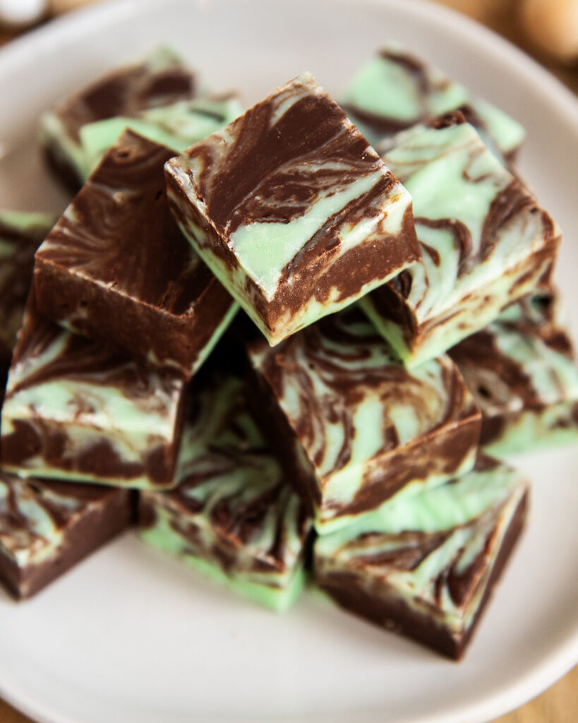 A close up of a plate of mint chocolate swirled fudge.