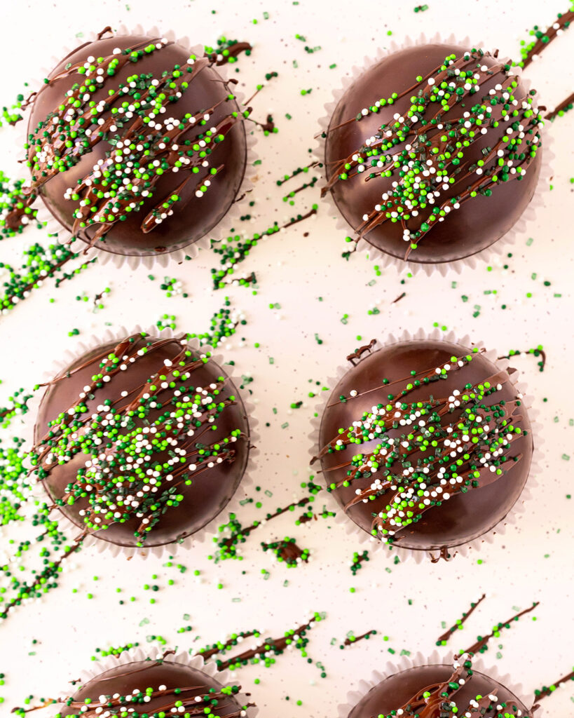 Hot Chocolate Bombs topped with green and white sprinkles.