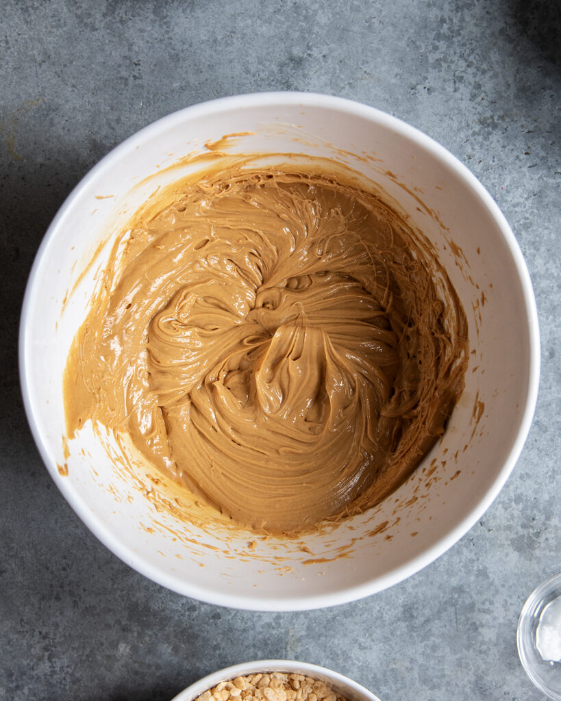 A bowl of peanut butter mixed with butter. 