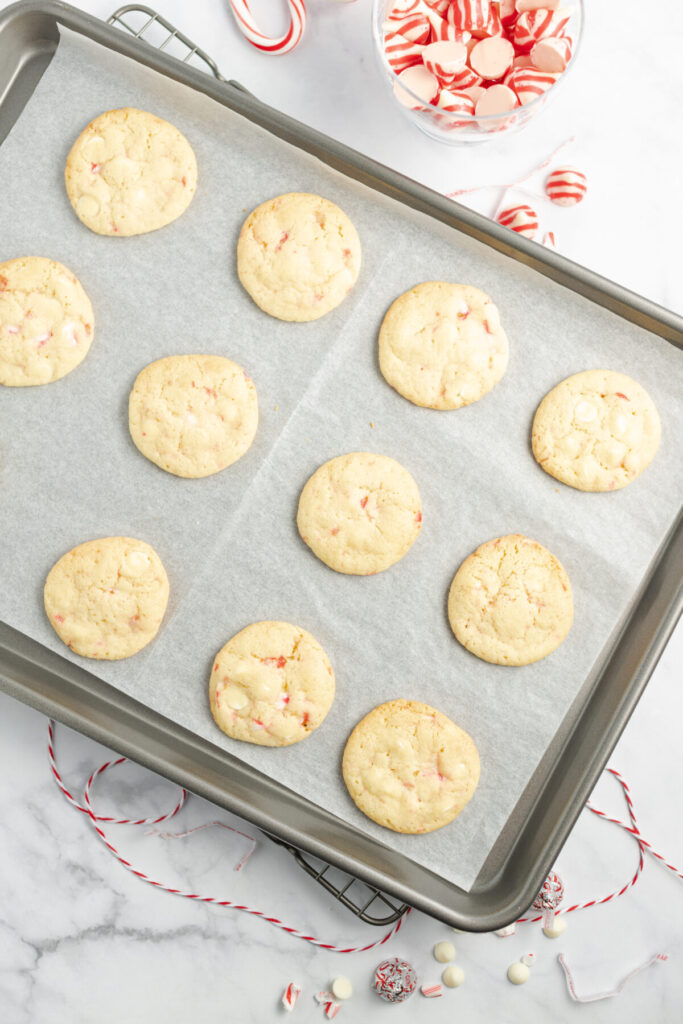 An above view of a baking pan topped with cooked sugar cookies.