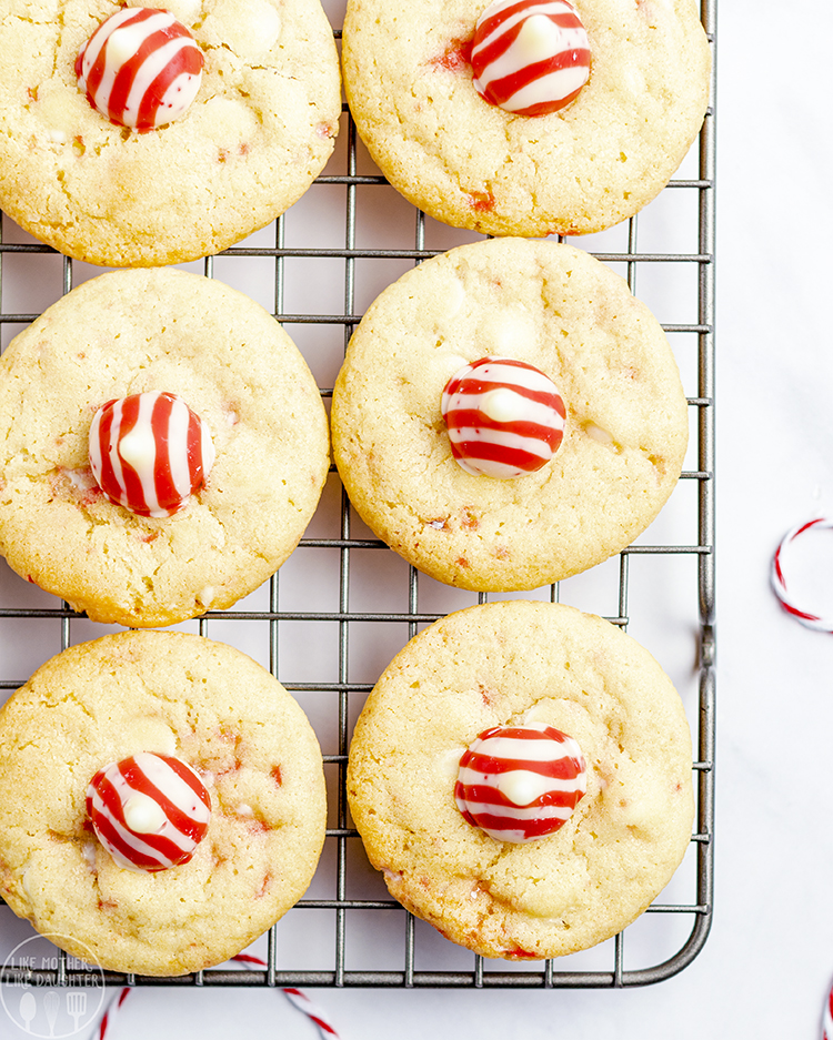 A close up of Candy Cane Kiss Cookies on a cooling rack.