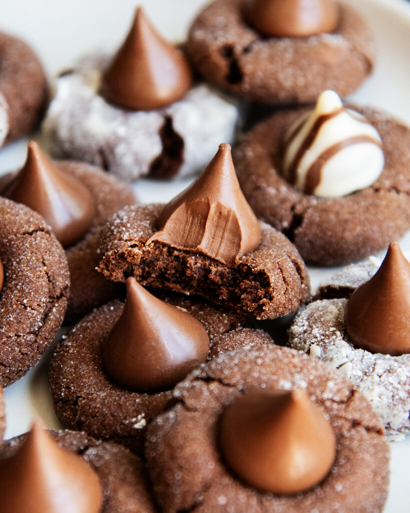 A chocolate blossom cookie with a bite out of it.