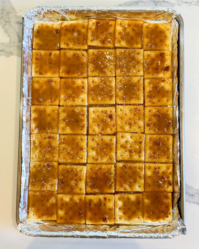 Rows of saltine crackers topped with brown bubbly toffee.