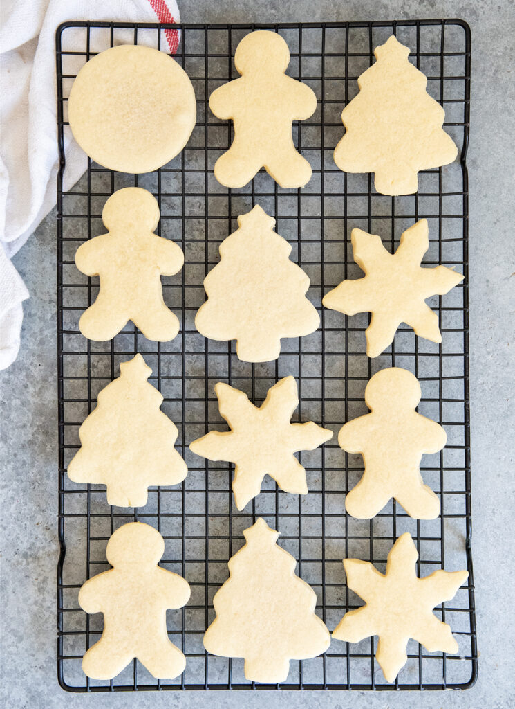 Christmas shaped sugar cookies on a cookie sheet.