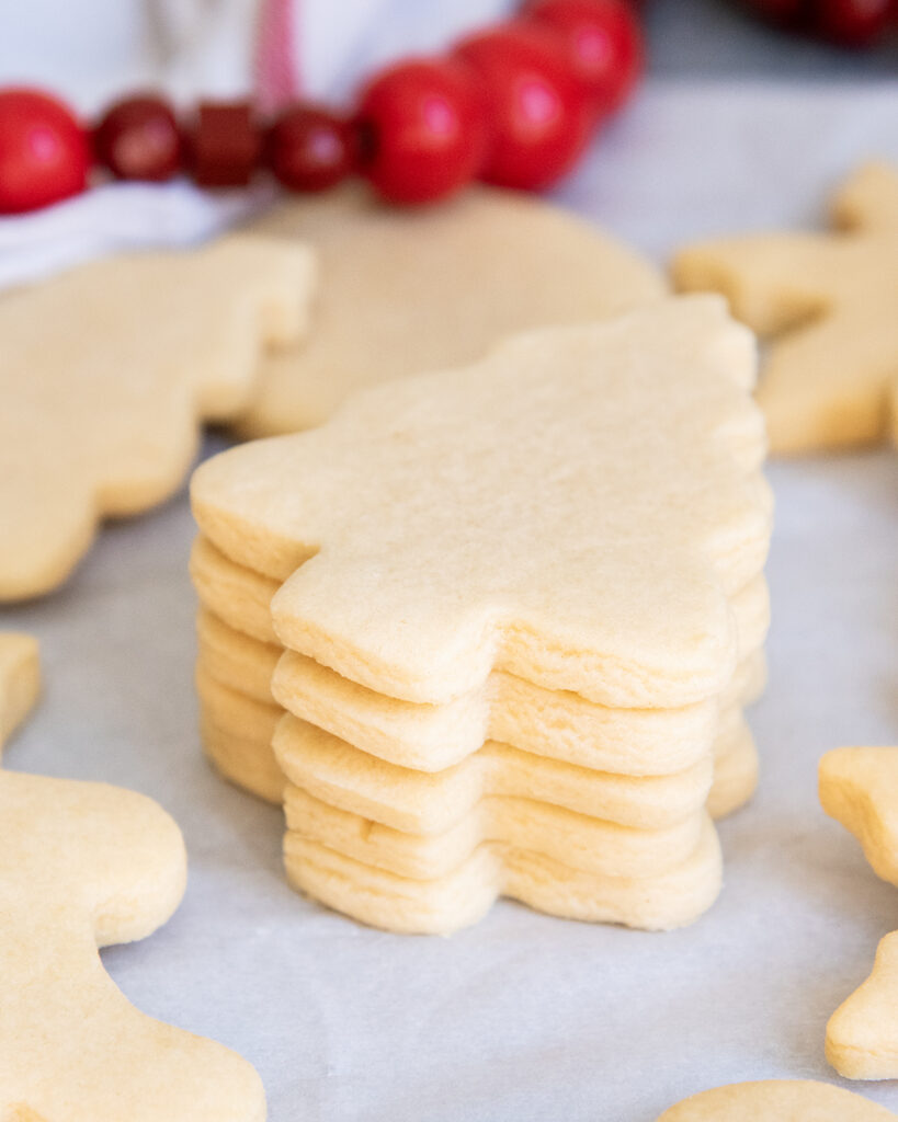 A stack of tree shaped cut out sugar cookies.