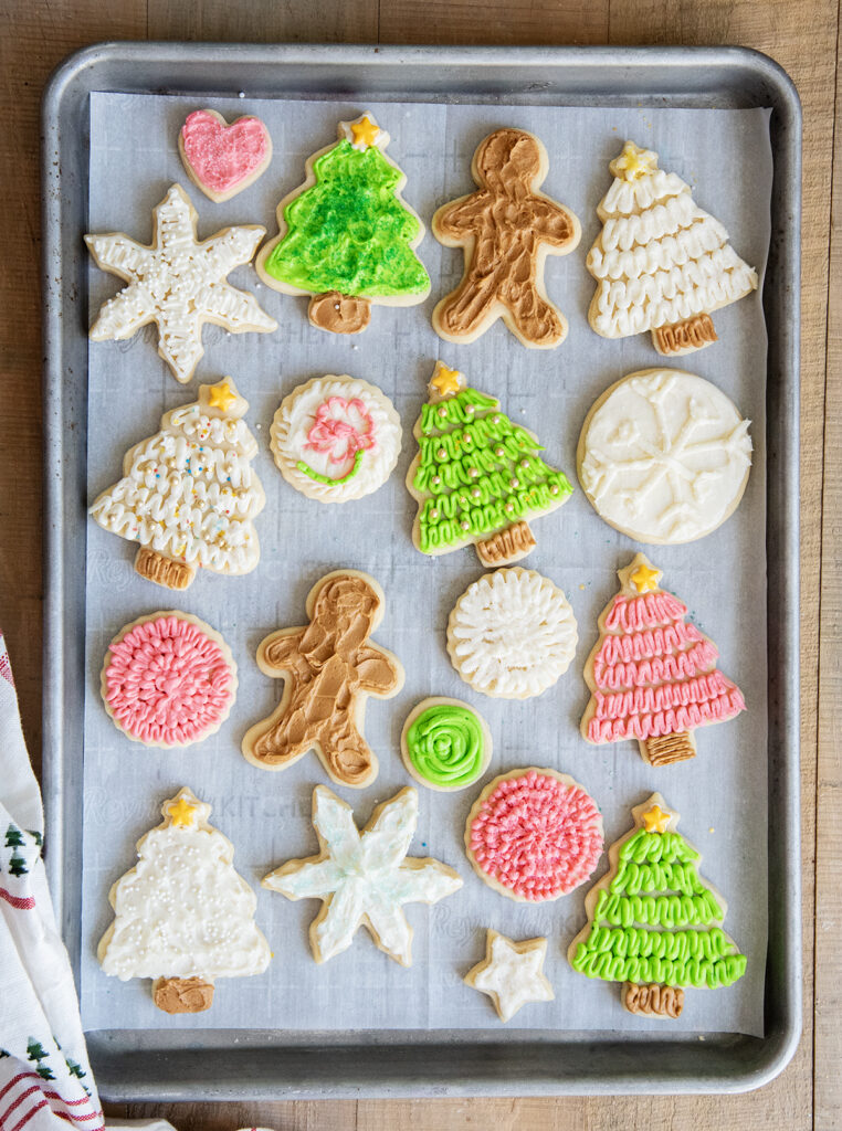 A cookie tray full of frosted cut out sugar cookies.