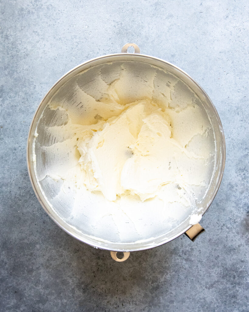 A mixing bowl of creamed butter and sugar.