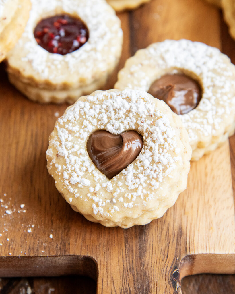 A heart topped sandwich cookie filled with Nutella.