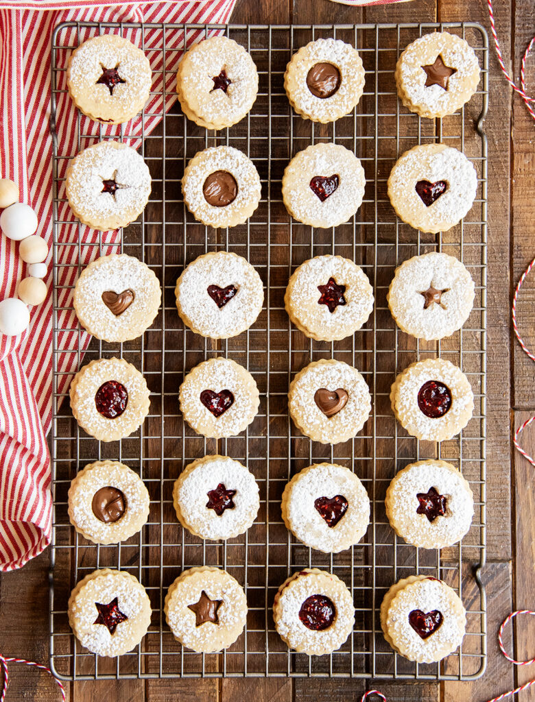 An above photo of Linzer sandwich cookies on a cooling rack.