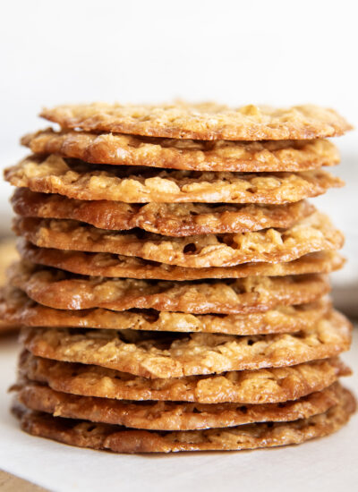 A stack of golden colored oatmeal lace cookies.