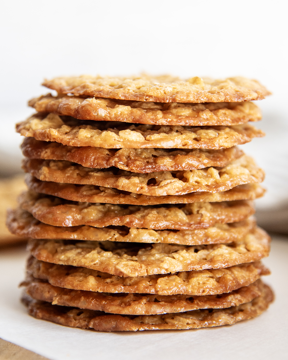 A stack of golden colored oatmeal lace cookies.