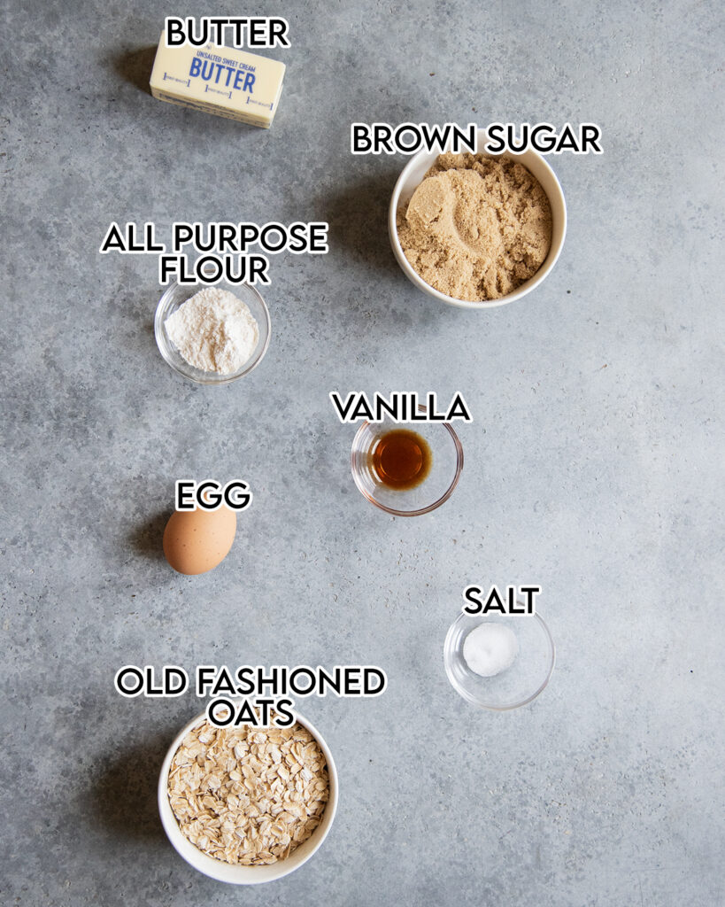 The ingredients needed to make oatmeal lace cookies in small bowls on a gray counter top. 