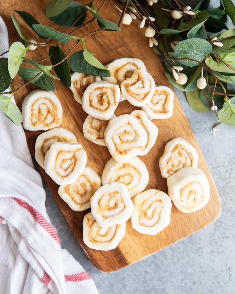 A pile of potato candy pieces on a wooden board.