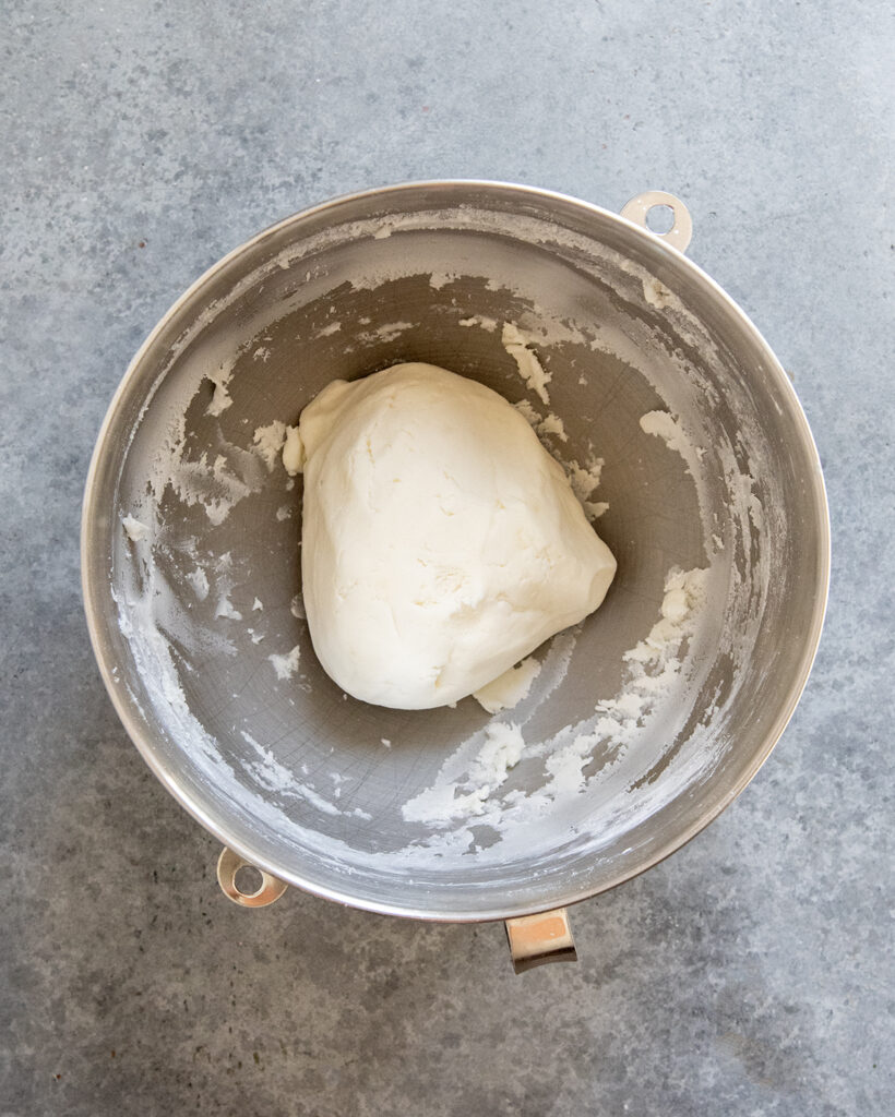 A bowl of powdered sugar potato candy. 