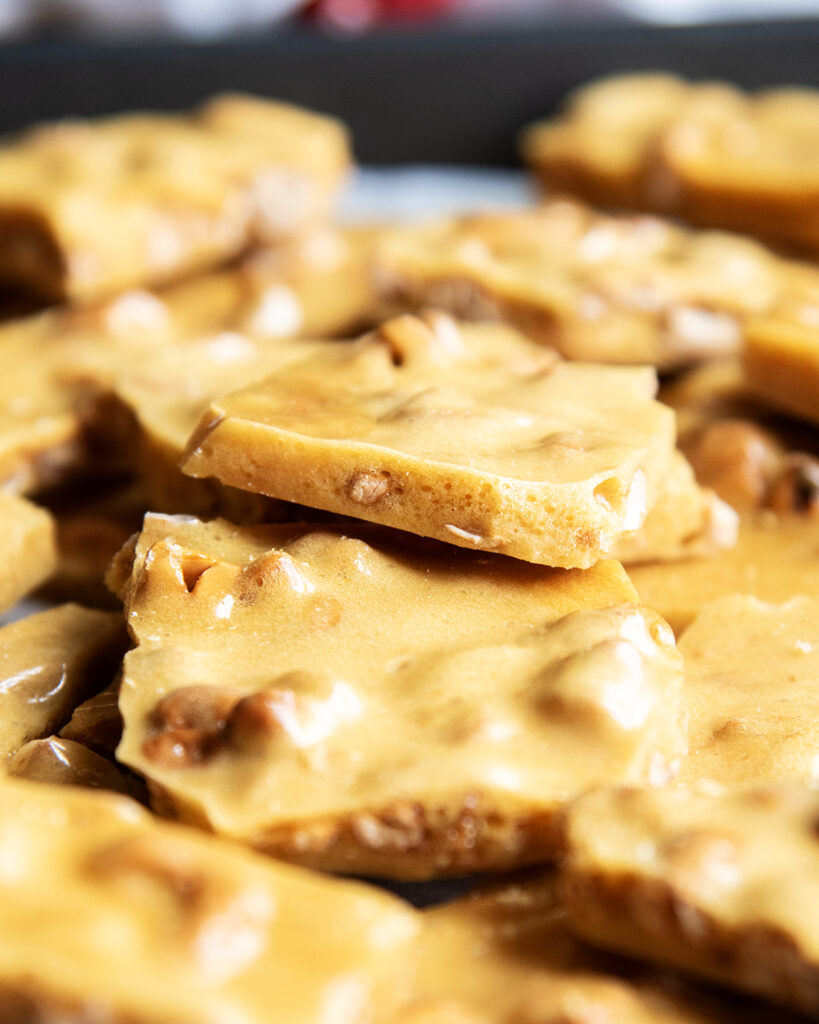 A side view of a piece of cashew brittle.