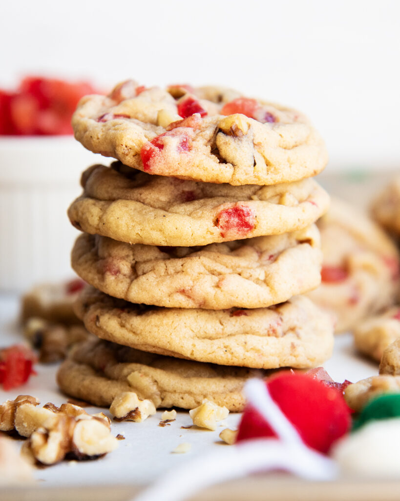 A stack of chewy fruitcake cookies full of dried fruit pieces and walnuts.