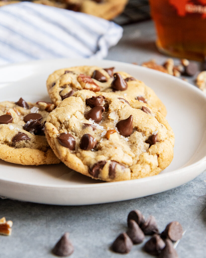 A plate of three pecan and chocolate chip cookies.