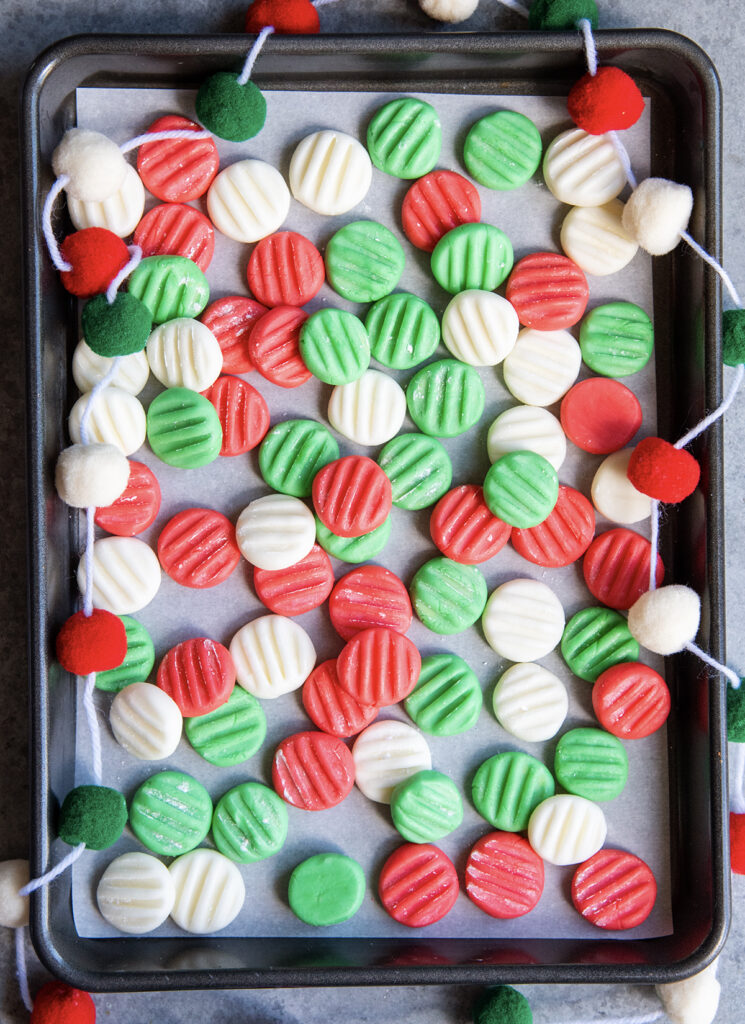 A pan of cream cheese mints in Christmas colors.