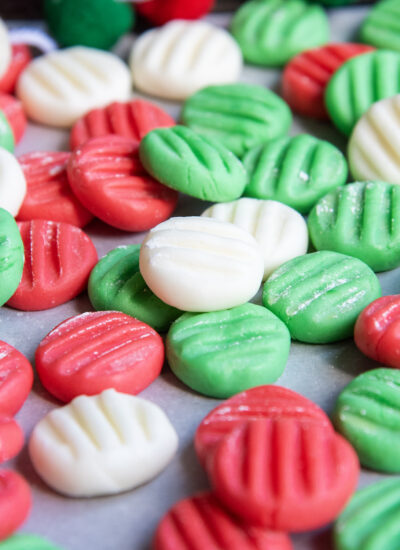 Red, white, and green cream cheese mints with fork tine impressions on the top.