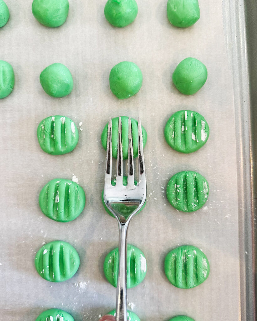 A fork pressing into a cream cheese mint.