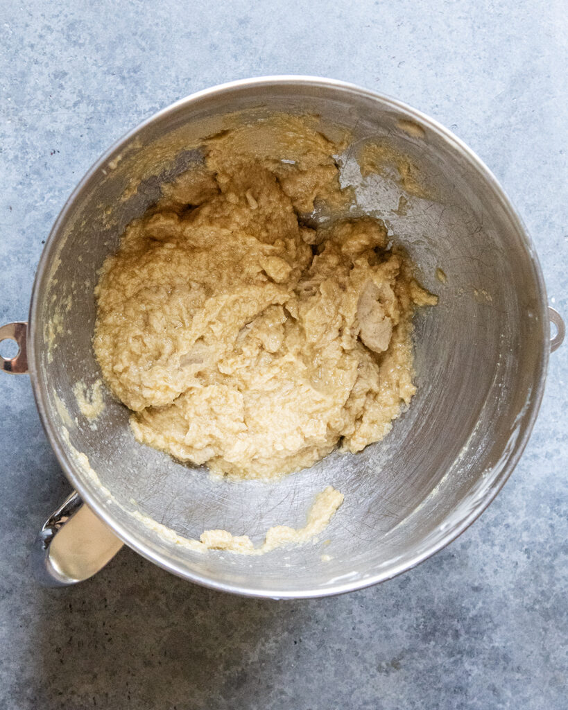 A bowl of the wet ingredients for cookie dough mixed in a large bowl. 