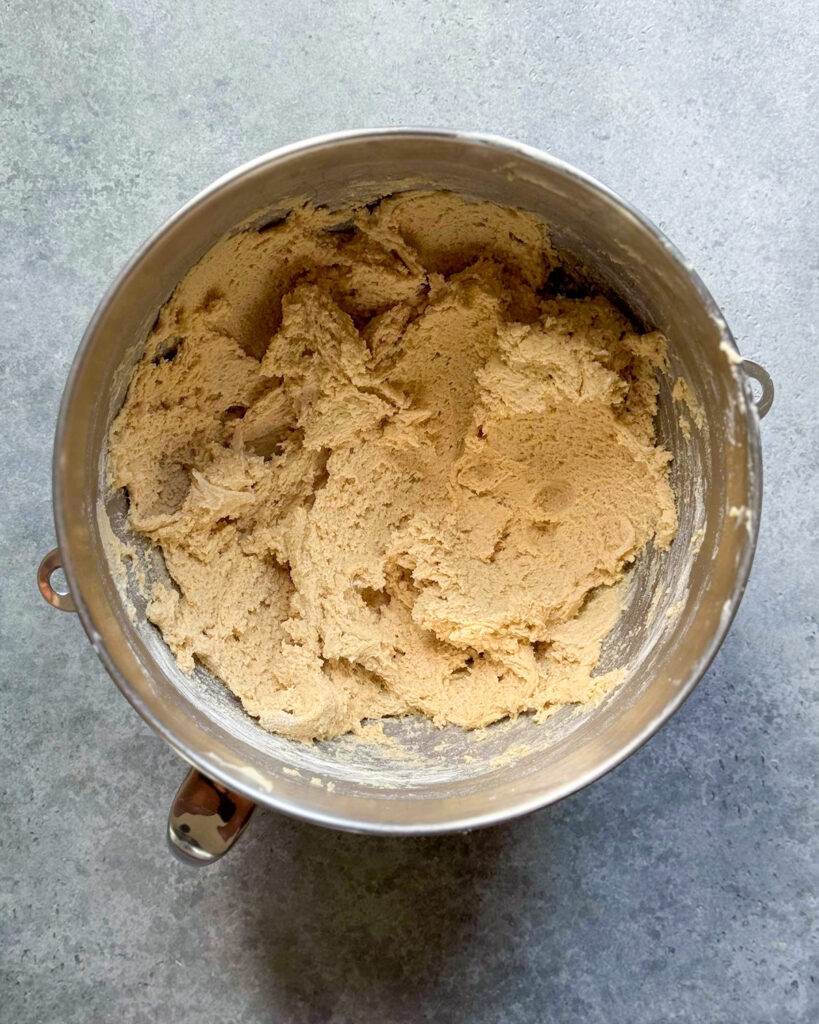 Cookie dough in a metal bowl.