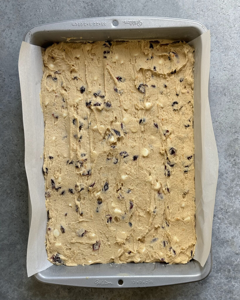 A rectangle pan filled with cookie dough. 