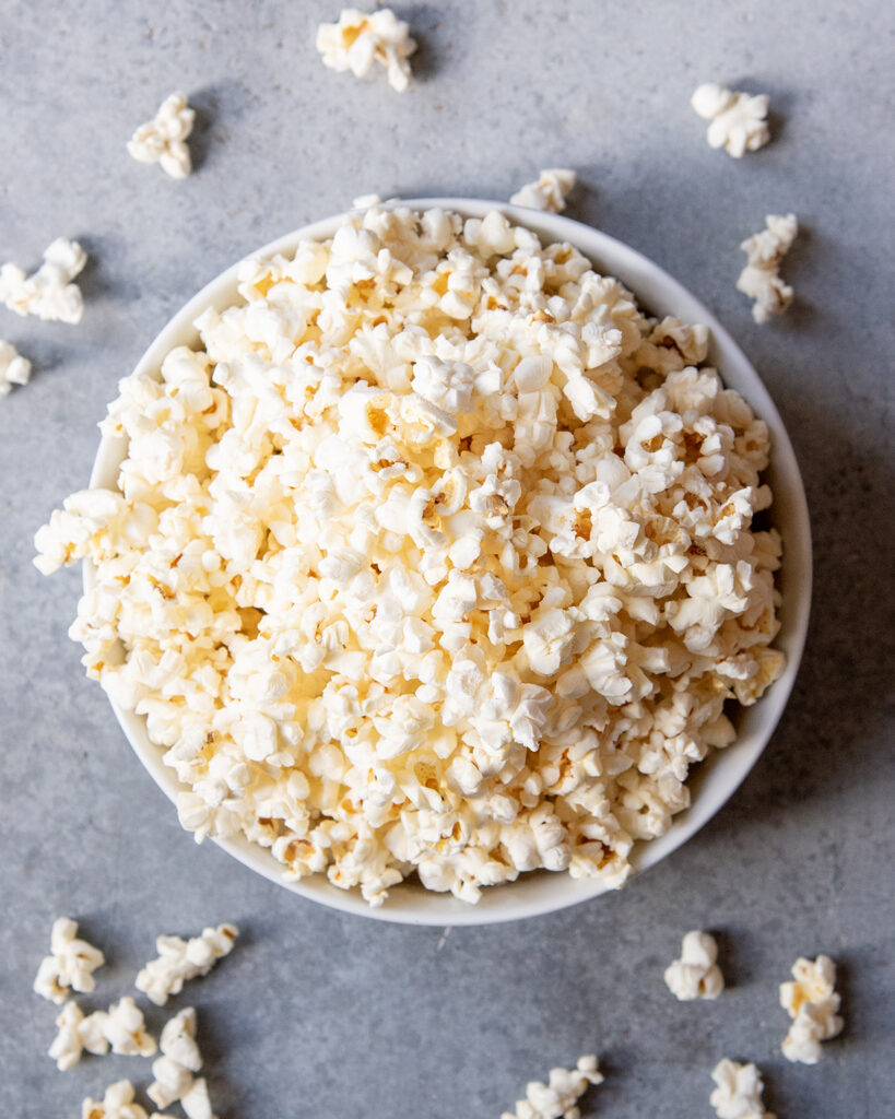 An above view of a bowl of popped popcorn.