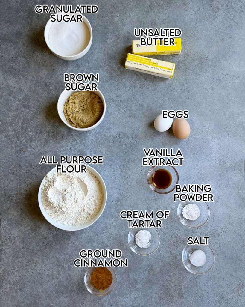 An above view of the ingredients needed to make snickerdoodle bars, in small bowls. 