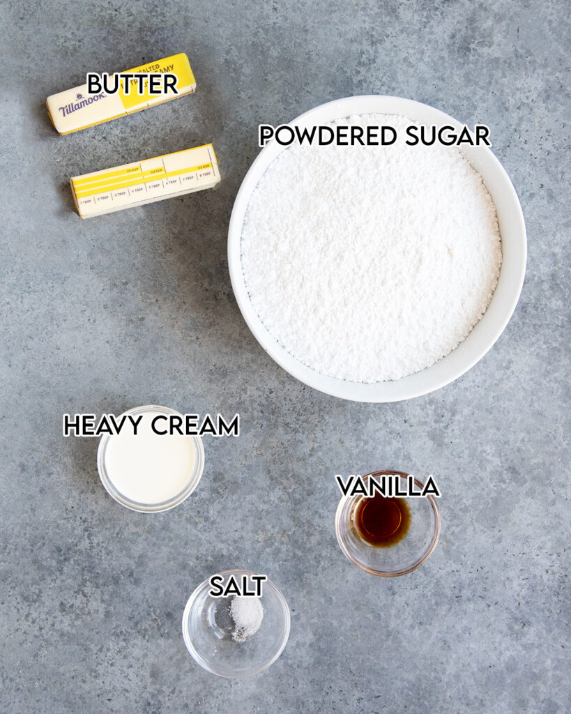 The ingredients needed to make buttercream frosting, powdered sugar, butter, cream, vanilla, and salt. 