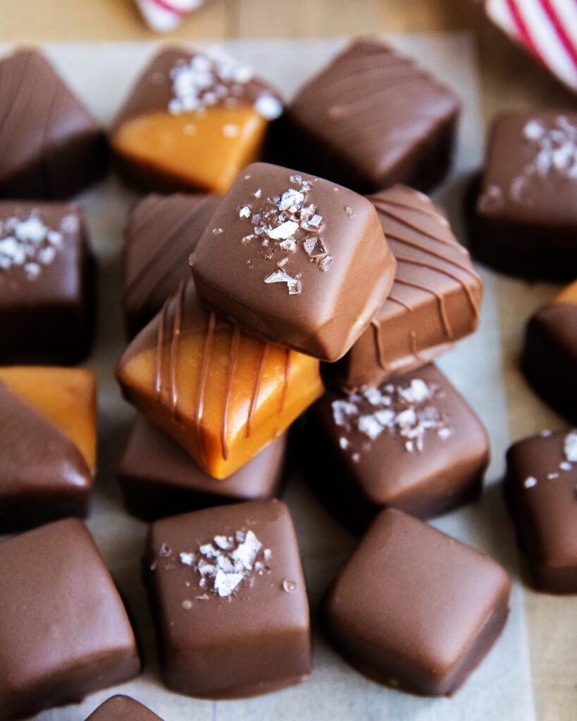 A pile of homemade chocolate covered caramels. 