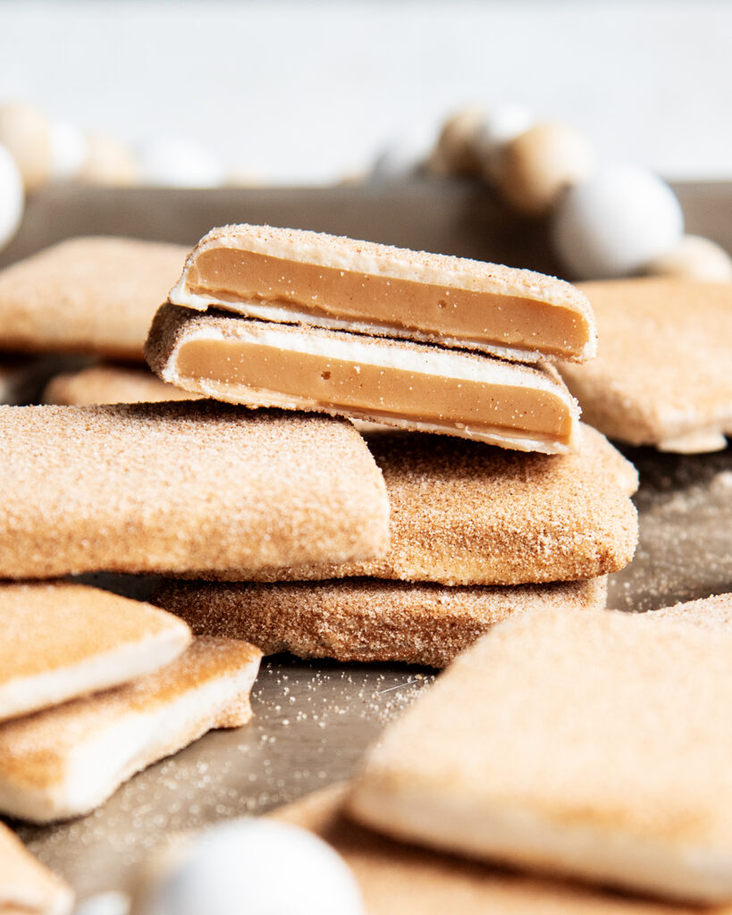 A pile of churro toffee coated in white chocolate.