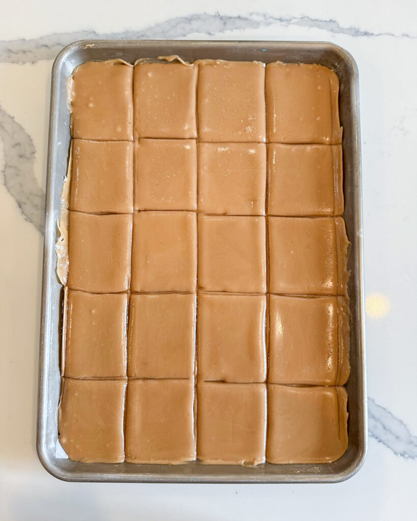 Squares of toffee in a baking pan.