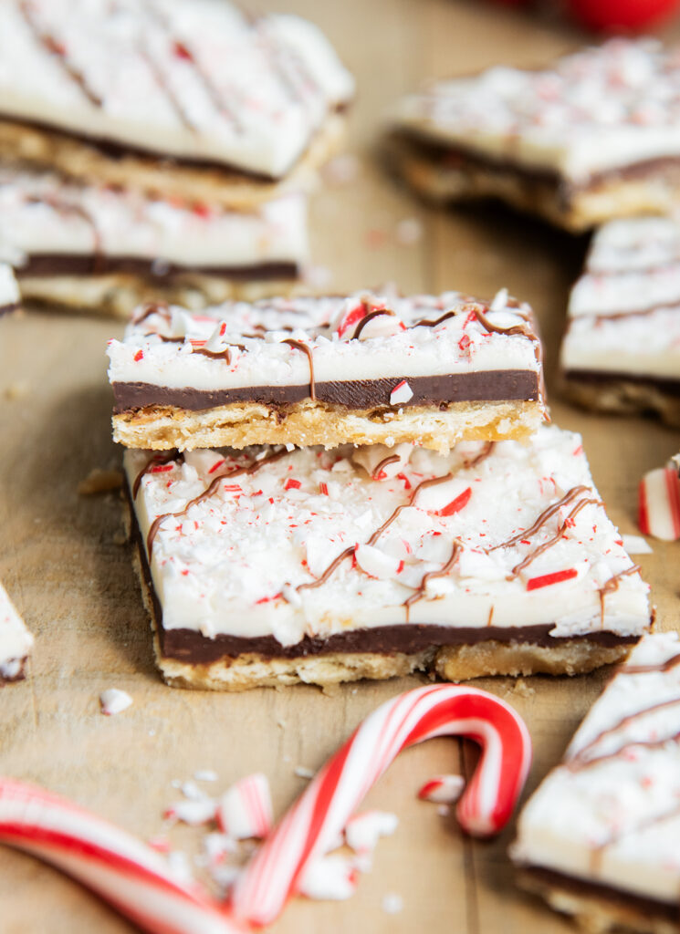 Pieces of peppermint bark cracker toffee laying on top of each other.