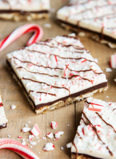 A piece of Peppermint Bark Cracker Toffee with cracker toffee on the bottom, and peppermint bark on the top of each.