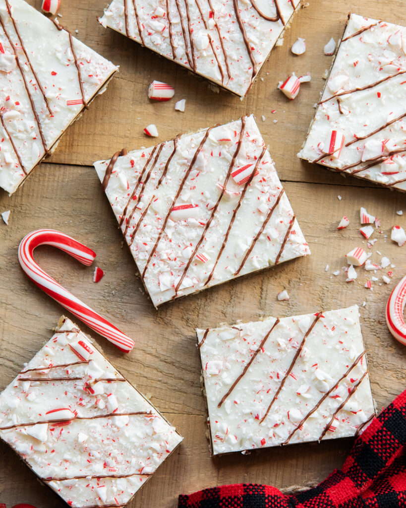 An above view of peppermint bark on a wooden table.